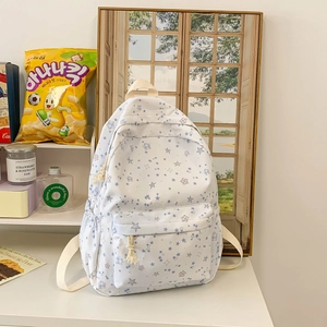 White canvas backpack with blue star prints and large capacity for school students