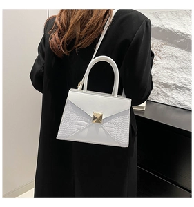 Detailed view of white crocodile pattern shoulder bag with a square golden metal buckle