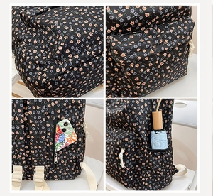 Detail view of floral backpack showing side mesh pocket and back anti-theft zipper pocket