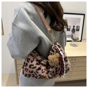 Détail du sac cabas en peluche léopard rose avec breloque ours et finitions dorées