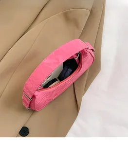 Interior view of pink pleated handbag showing ample space for smartphone and cosmetics