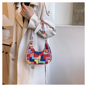Detail of a chic crescent felt underarm bag with vibrant geometric pop art patchwork style