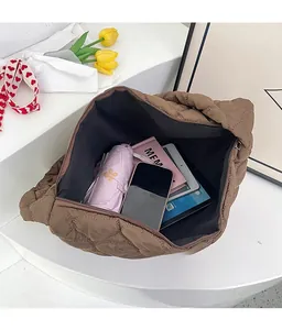 Interior view of brown quilted tote bag showing large capacity for tablet and umbrella