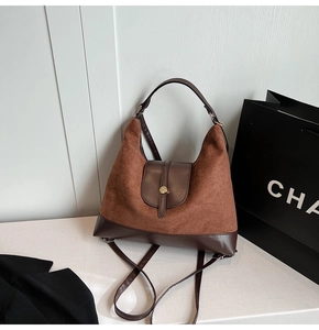 Close-up of retro brown suede and leather stitching with a vintage metal buckle detail
