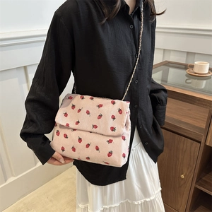 Pink corduroy crossbody bag with strawberry print and gold chain strap for women