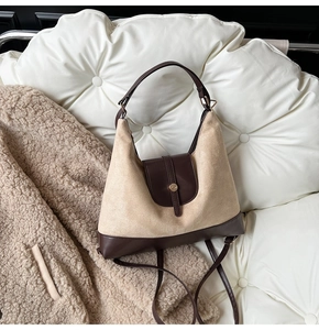 Detail of retro contrasting textures on a large shoulder tote bag with soft suede and leather