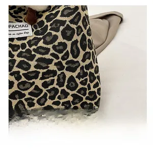 Close-up of leopard print nylon fabric with brand label and plush decorative charm