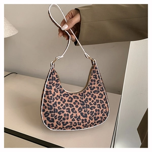 Close-up of leopard print hobo bag with contrast white trim and metallic zipper detail