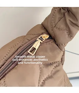 Close-up of premium gold-toned metal zipper and quilted texture on a coffee tote bag