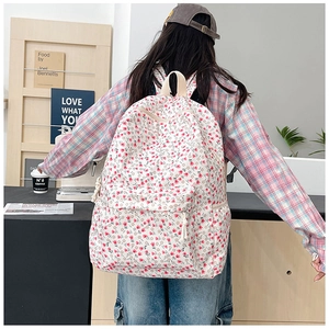 Close-up detail of floral backpack with pink tulips and reinforced top handle strap
