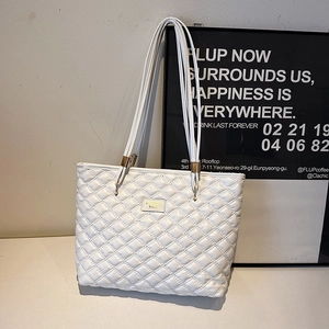 White quilted tote bag with diamond pattern and metal fashion plaque on shoulder straps