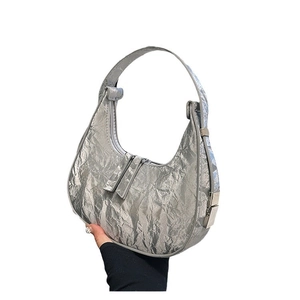 Silver metallic pleated crescent hobo bag with a minimalist design for women fashion