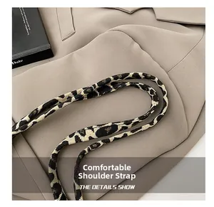 Detail view of woven leopard print shoulder strap featuring thick texture and cozy design