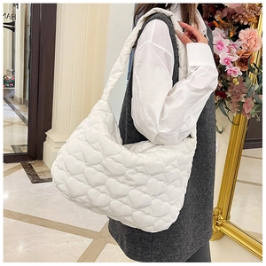 Close-up of white heart-quilted tote bag with premium down-like puffer texture