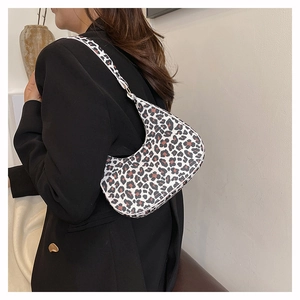 Detail view of stylish leopard print hobo bag worn with a chic dark blazer