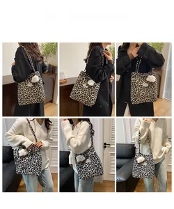 Detailed views of leopard print tote bag with white cloud plush charm on shoulder