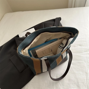Interior view of striped canvas tote bag showing large capacity for books and tablet