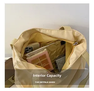 Detail view of spacious inner capacity of cream canvas tote bag with various daily essentials