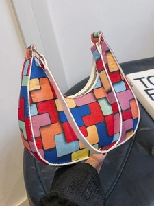 Colorful geometric felt underarm bag with vibrant blocks and a white shoulder strap