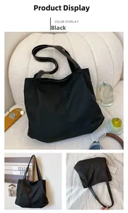 Three-way view of a large black nylon tote bag shown in a cozy home setting