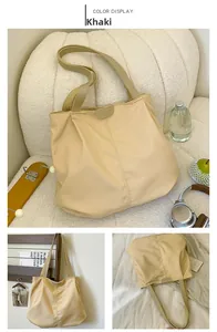 Detail of khaki nylon tote bag showing premium leather handles and fashion logo patch