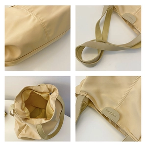Detail view of beige canvas tote bag with strap texture, interior pocket and logo