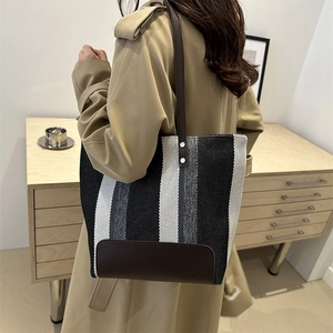 Striped canvas tote bag with leather straps and silver rivets for woman fashion look
