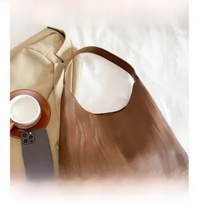 Detailed macro view of dark brown hobo bag showing unique water wave texture finish