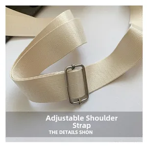 Detail of adjustable beige nylon strap with silver metal slider buckle for handbag