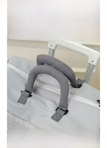 Detail of light grey gym bag with soft padded handles and luggage trolley sleeve attachment