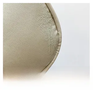 Detailed macro view of the premium champagne satin fabric and elegant jacquard patterns
