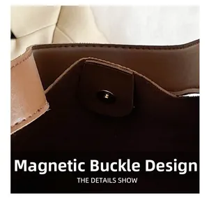 Detail view of the secure magnetic closure on the brown leather tote bag interior