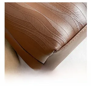 Macro detail of brown leather tote bag showing chevron texture and precision stitching