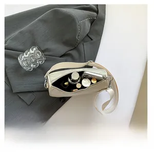 Detailed internal view showing the large capacity of this cream embroidered crossbody bag