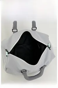Detail view of spacious main compartment in gray gym bag with black lining and zipper