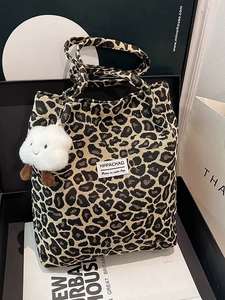 Fashionable leopard print tote bag with plush cloud charm and woven texture nylon finish