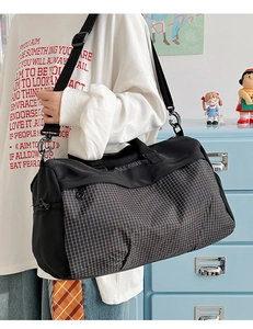 Large black fitness travel bag with plaid patterns and adjustable shoulder strap