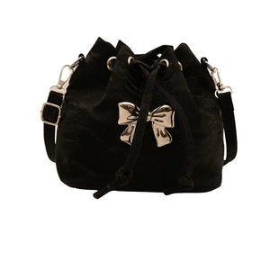 Fashionable black drawstring bucket bag with a metallic silver bow accent and adjustable strap