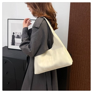 Detail of off-white hobo bag showing its unique vertical pleated texture and leather material