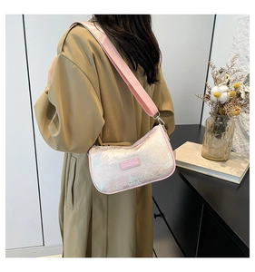Detail of light pink jacquard crossbody bag with traditional Chinese landscape patterns