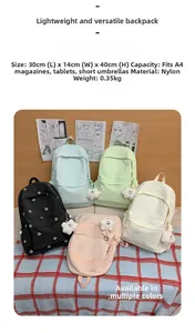 Close-up of lightweight nylon backpack showing floral embroidery and soft plush charm detail