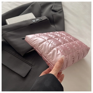 Close-up of pink quilted nylon makeup bag with soft texture and glossy silk finish