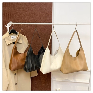 Detailed view of large tote bags in four colors with vertical ripple embossed texture