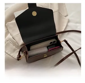 Detail showing the internal storage capacity of the dark brown crossbody square bag