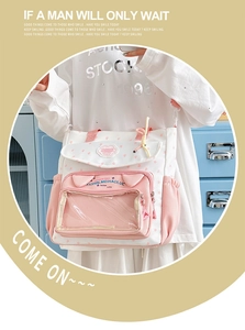 Close-up of white canvas tote bag with pink star patterns and a transparent front window