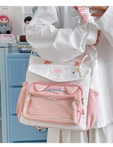 Detail of canvas student tote bag featuring cat ear decor and transparent front window pocket