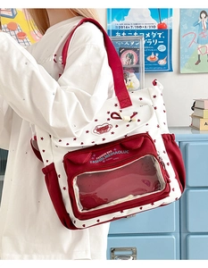 Detail of red and white anime tote bag with stars and transparent display window