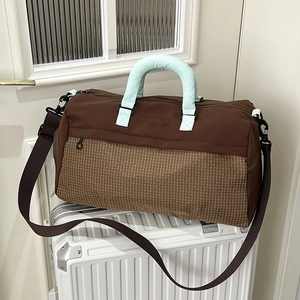 Large capacity travel duffel bag with brown plaid stitching and adjustable shoulder strap