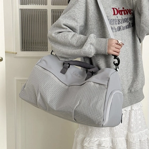Large gray gym bag with white grid pattern and adjustable shoulder strap for travel