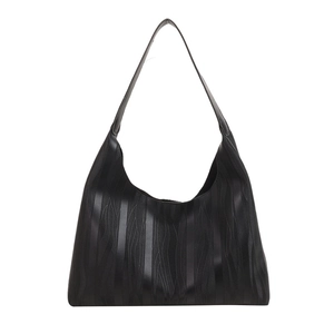Minimalist black tote bag with wave texture and wide shoulder strap in matte finish